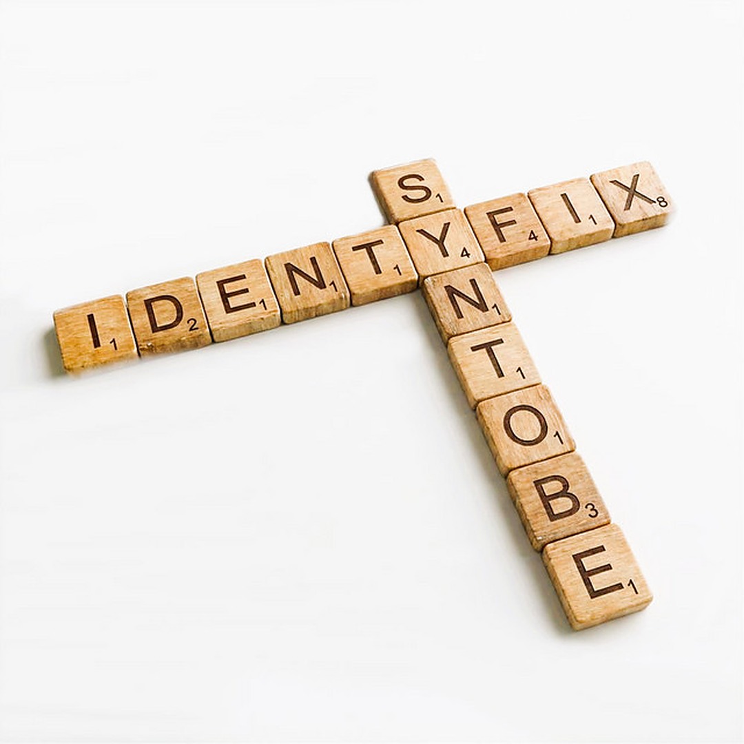 Identyfix cover art — wooden letter tiles spelling Identyfix and SynToBe